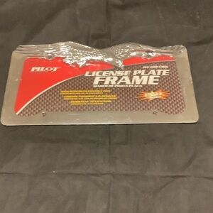 Red and Silver License Plate Frame. Never opened still in plastic.
